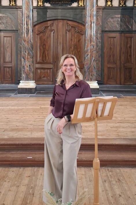 Dagvoorzitter Yvonne Dijkstra bij een lessenaar voor een historisch kerkorgel